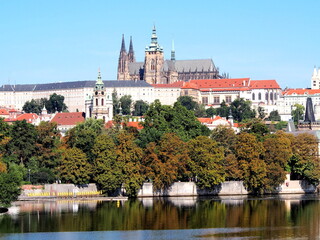 Obraz premium view of Prague from the deck of a steamer, historical city center, panorama on the Vltava, sunny summer day, tourism