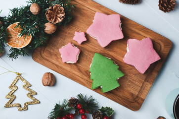 Christmas composition. Festive cookies in star and tree form on wooden background.
