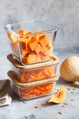 Glass boxes with fresh raw orange vegetables. Finaly shredded pumpkin and big pieces. Healthy Meal Prep, recipe preparation photos. Healthy vegan dishes in glass containers. Weight loss food concept