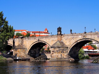 Fototapeta premium view of Prague from the deck of a steamer, historical city center, panorama on the Vltava, sunny summer day, tourism