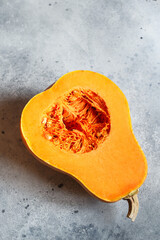 Fresh butternut squash on the grey background. Butternut Pumpkin. Halves of raw orange pumpkin. Contrast photo. Healthy Meal Prep, recipe preparation photo. Seasonal pumpkin cooking