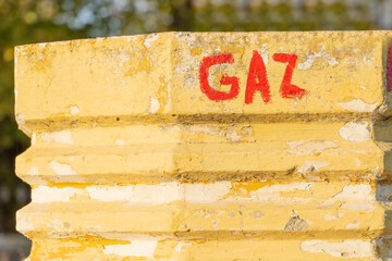 Gas graffiti pole yellow red urban close up