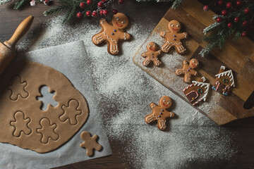 Cooking Christmas gingerbread cookies on a dark background

