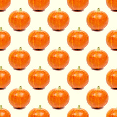 Yellow and orange pumpkin repeat seamless pattern on light background.