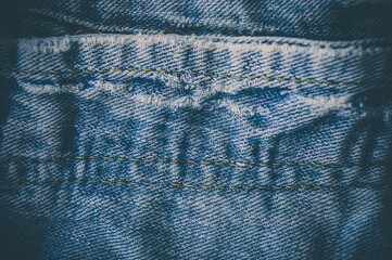 clothing items blue stonewashed faded jeans cotton fabric texture with seams, clasps, buttons and...