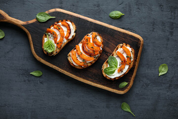 Sandwiches with cream cheese and baked pumpkin slices. Autumn recipes for snacks. View from above.