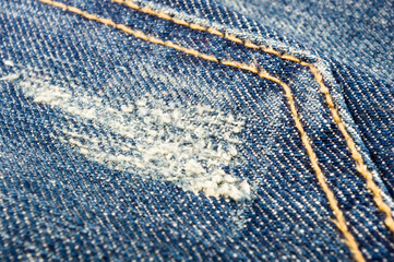 clothing items blue stonewashed faded jeans cotton fabric texture with seams, clasps, buttons and...