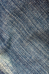 clothing items blue stonewashed faded jeans cotton fabric texture with seams, clasps, buttons and...