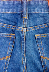 clothing items blue stonewashed faded jeans cotton fabric texture with seams, clasps, buttons and...