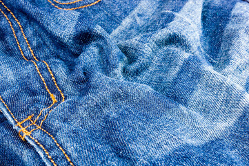 clothing items blue stonewashed faded jeans cotton fabric texture with seams, clasps, buttons and...