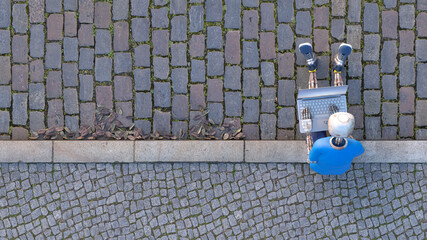 Robot sitting on curb using laptop, 3d rendering