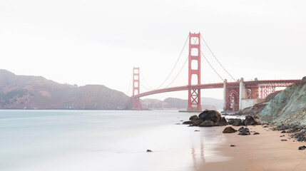 Water's edge with Golden Gate Bridge against clear sky at San Francisco, California, USA