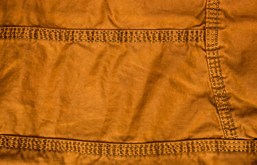 clothing items stonewashed cotton fabric texture with seams, clasps, buttons and rivets, macro