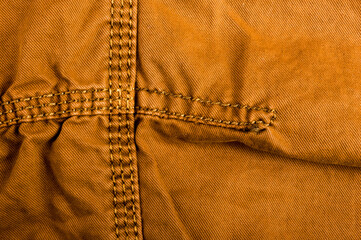 clothing items stonewashed cotton fabric texture with seams, clasps, buttons and rivets, macro