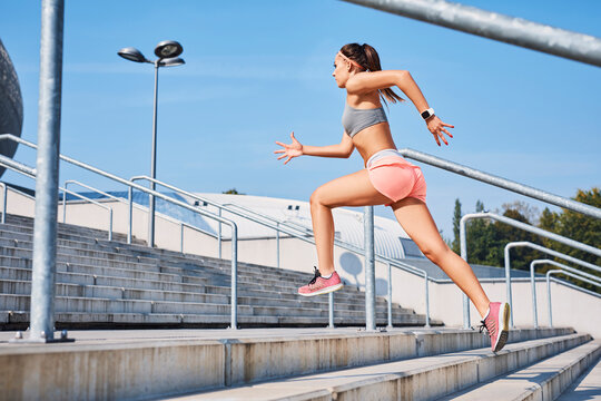 Fit young woman running on stairs