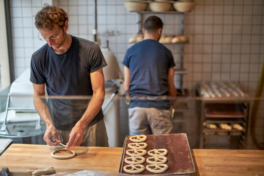 Bakers in bakery preparing fresh pretzls