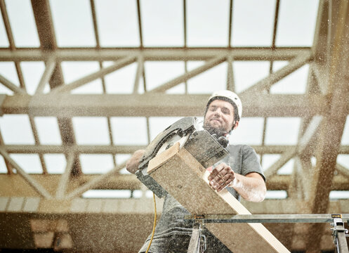 Austria, worker sawing wood
