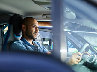Young man driving electric car