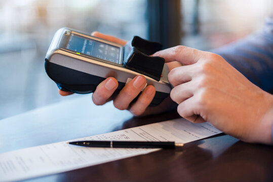 Man using credit card reader, close-up