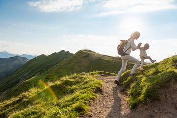Germany, Bavaria, Oberstdorf, mother and little daughter on a hiking trip in the mountains