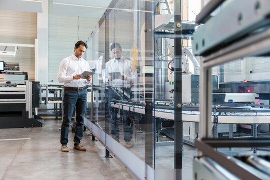 Businessman using tablet in modern factory