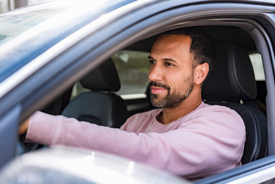 Smiling man driving car