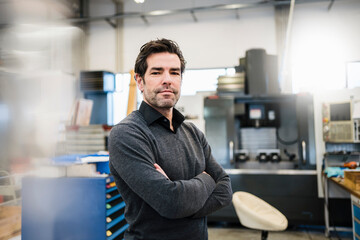 Portrait of a confident businessman in a factory