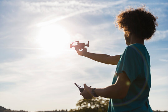 Boy flying a drone outdoors