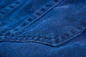 clothing items stonewashed cotton fabric texture with seams, clasps, buttons and rivets, macro