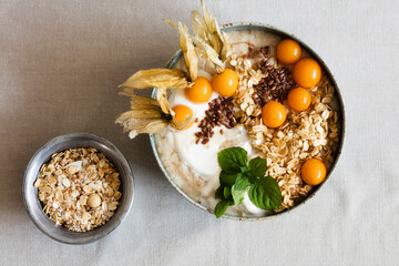 Bowl of porridge with oats, flax seed and winter cherries