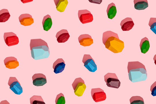 Colorful wooden block against pink background