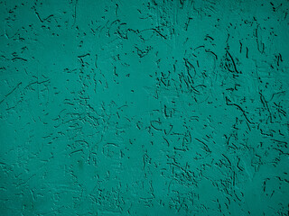 Dark green concrete wall. Textured with deep furrows.