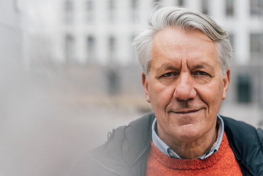 Portrait of confident senior man outdoors