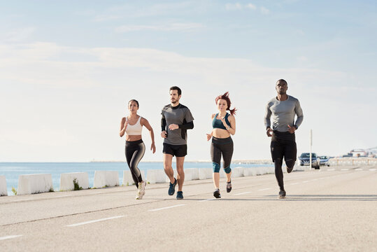 Group of sportspeople jogging at harbour
