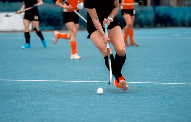Women battle for control of ball during field hockey game. Sport team concept. Vintage color filter