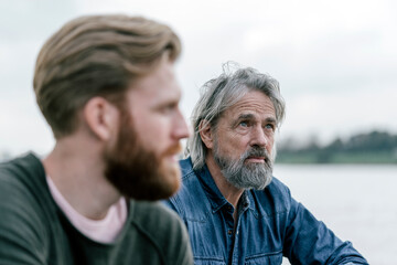 Father and son meeting outdoors, portrait