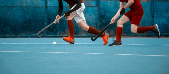 Two man battle for control of ball during field hockey game. Sport team concept. Vintage color...