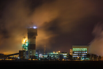 Fototapeta premium night industrial landscape environmental pollution waste of thermal power plant. Big pipes of chemical industry enterprise plant