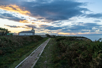 view of the Cabo de Busto lighthouse at sunset