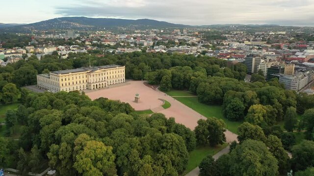 Oslo, Norway. Beautiful 4K panoramic aerial video from flying drone to Oslo of the Royal Palace and Statue of King Karl Johan. In the background the castle park, the city and the mountains (Series)