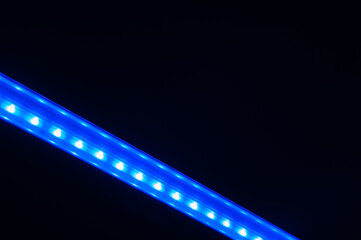 Obraz premium Abstract diagonal blue line of lights in dark.