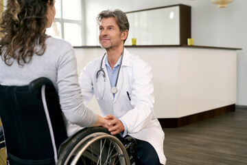Doctor taking care of female patient in wheelchair
