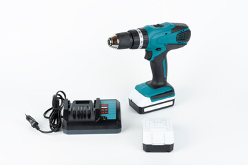 Cordless hammer screwdriver drill, battery charger and second battery on white background. Studio...