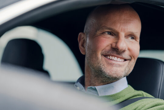 Portrait of smiling mature man in car