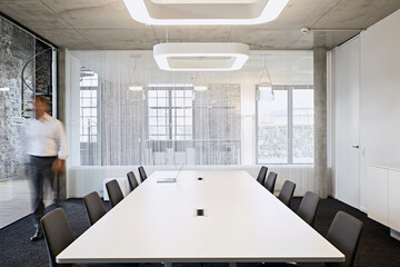 Businessman walking in modern conference room