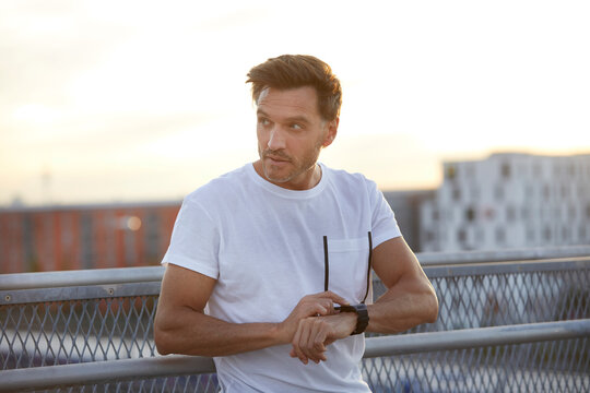 Athlete in the city with smartwatch