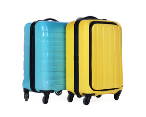Stylish suitcases packed for travel on white background. Summer vacation