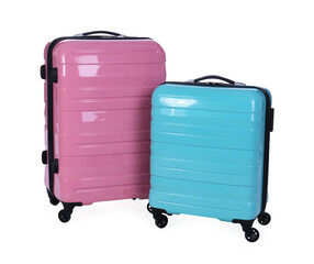 Stylish suitcases packed for travel on white background. Summer vacation