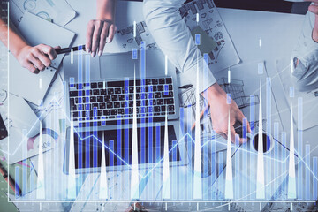 Double exposure of man and woman working together and financial graph hologram. Business concept. Computer background.