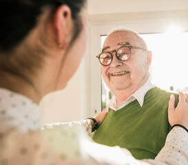 Senior man smiling at young woman